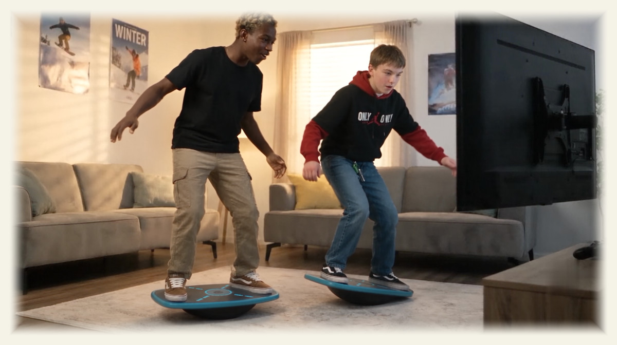Two boys on GoBalance boards playing the same game on one television