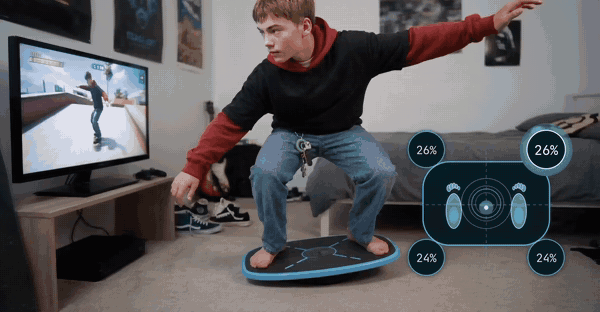 A boy riding the GoBalance board, with his weight readout moving as he leans
